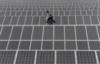 employee-walks-solar-panels-solar-power-plant-aksu-xinjiang-uyghur-autonomous-region-may-18-2012.jpg